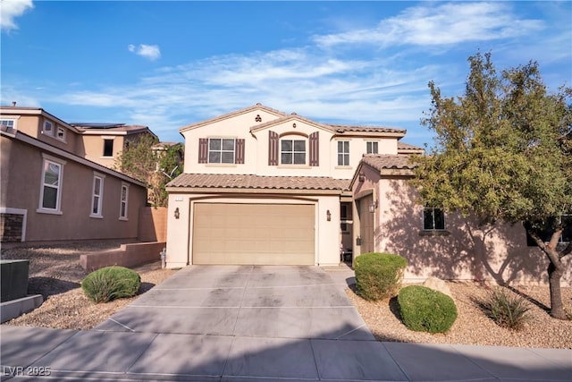 mediterranean / spanish-style home featuring a tile roof, an attached garage, stucco siding, and concrete driveway