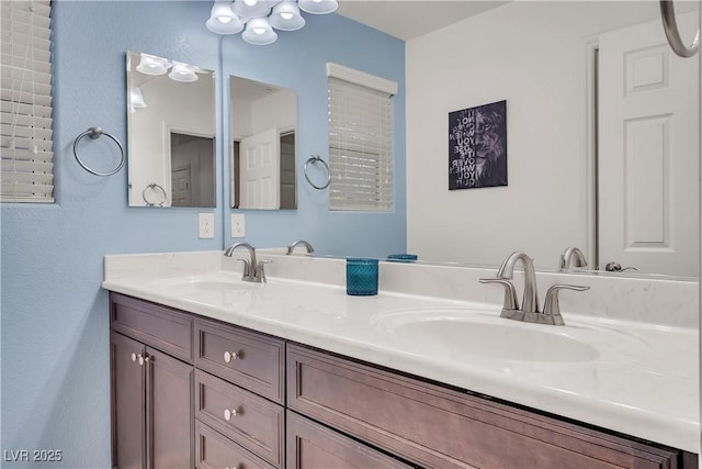 full bathroom with double vanity and a sink