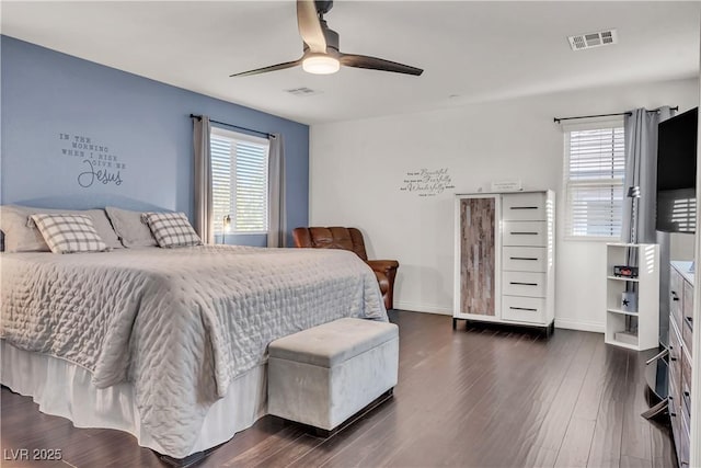 bedroom featuring dark wood-style flooring, visible vents, baseboards, and a ceiling fan