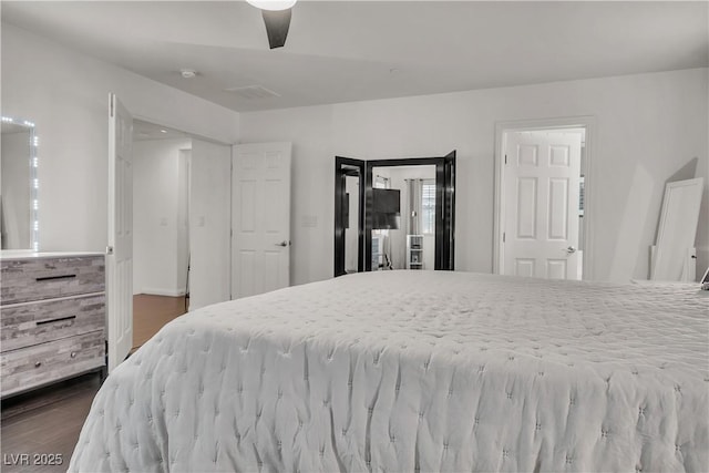 bedroom featuring dark wood-type flooring and ceiling fan