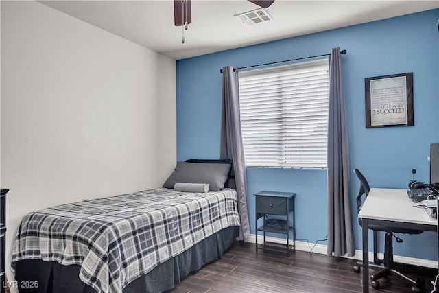 bedroom with visible vents, baseboards, ceiling fan, and dark wood-style floors
