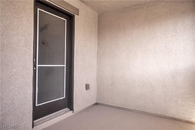 view of exterior entry featuring stucco siding