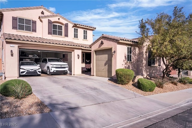 mediterranean / spanish house with concrete driveway, stucco siding, a garage, and a tile roof