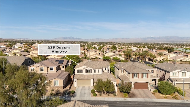 birds eye view of property with a mountain view and a residential view