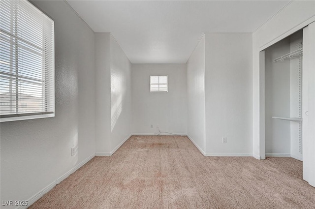unfurnished bedroom with a closet, baseboards, and carpet floors