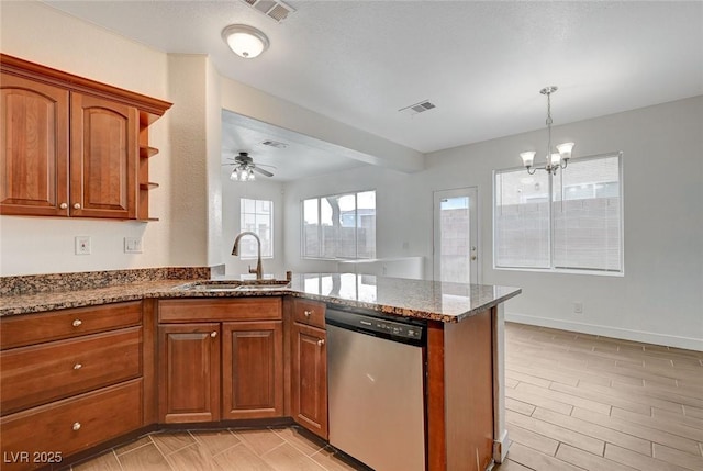 kitchen with a sink, visible vents, a peninsula, and dishwasher