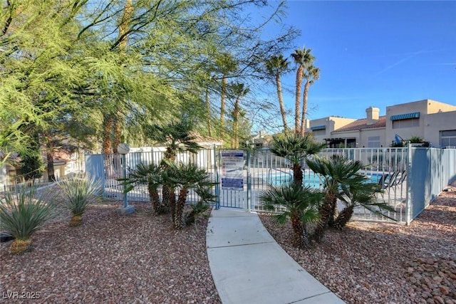 view of community featuring fence and a gate