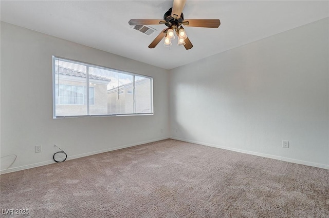 spare room with visible vents, baseboards, a ceiling fan, and carpet