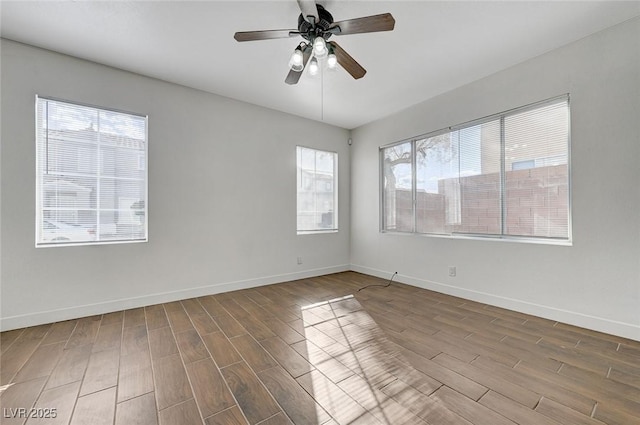 spare room with ceiling fan, baseboards, and wood finished floors