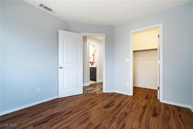 2401 Rice Flower Cir, Las Vegas, NV 89134 - unfurnished bedroom with wood finished floors, a spacious closet, baseboards, and a closet