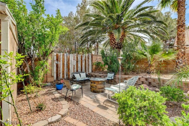 2401 Rice Flower Cir, Las Vegas, NV 89134 - view of patio with an outdoor fire pit and a fenced backyard