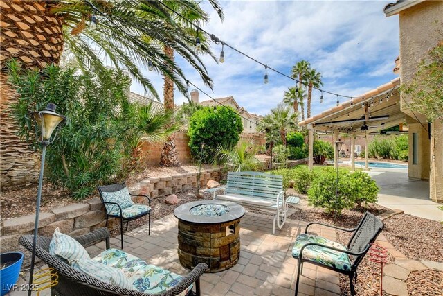 2401 Rice Flower Cir, Las Vegas, NV 89134 - view of patio featuring a fire pit, ceiling fan, an outdoor pool, and a fenced backyard
