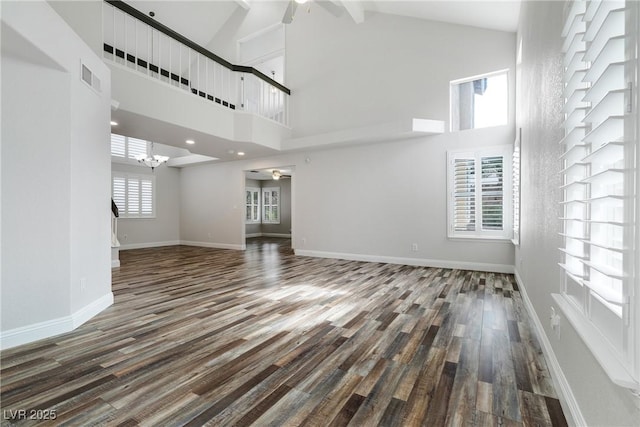 2401 Rice Flower Cir, Las Vegas, NV 89134 - unfurnished living room with wood finished floors, high vaulted ceiling, a chandelier, baseboards, and a ceiling fan