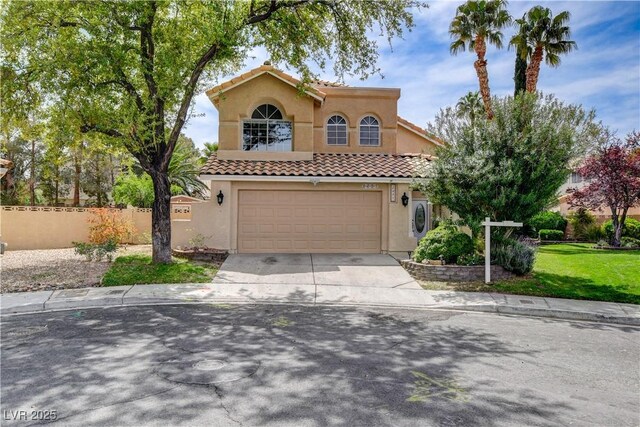 2401 Rice Flower Cir, Las Vegas, NV 89134 - mediterranean / spanish-style house with stucco siding, a tile roof, an attached garage, driveway, and fence