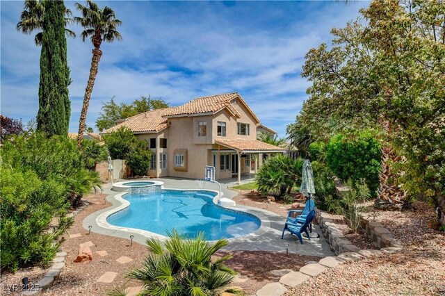2401 Rice Flower Cir, Las Vegas, NV 89134 - view of pool featuring a patio area, a pool with connected hot tub, and fence