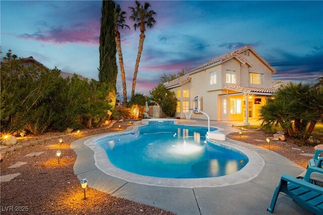 2401 Rice Flower Cir, Las Vegas, NV 89134 - pool at dusk with a pool with connected hot tub and a patio