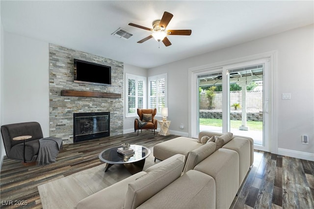 2401 Rice Flower Cir, Las Vegas, NV 89134 - living room with baseboards, a ceiling fan, wood finished floors, and a stone fireplace