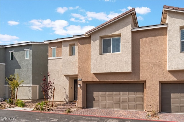 2902 Hemi Orange Ave, North Las Vegas, NV 89086 - multi unit property with stucco siding, decorative driveway, and an attached garage