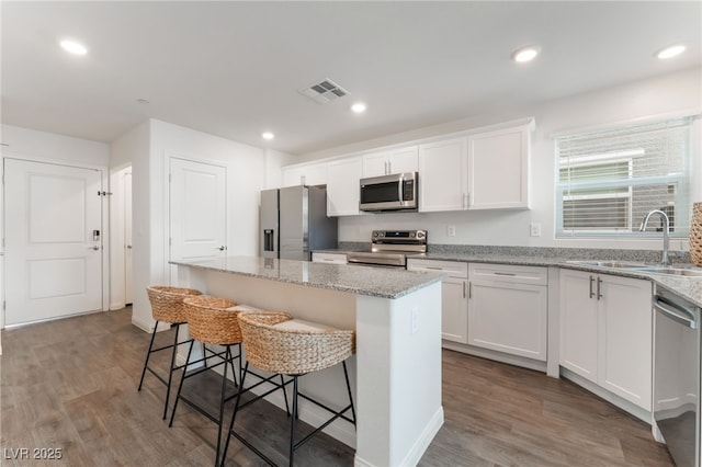 2902 Hemi Orange Ave, North Las Vegas, NV 89086 - kitchen with a kitchen breakfast bar, a center island, visible vents, stainless steel appliances, and a sink