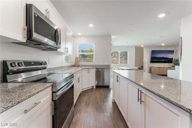 2902 Hemi Orange Ave, North Las Vegas, NV 89086 - kitchen featuring stainless steel appliances, recessed lighting, dark wood-style floors, and white cabinetry
