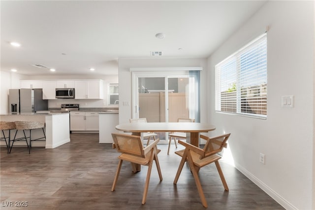 2902 Hemi Orange Ave, North Las Vegas, NV 89086 - dining room featuring dark wood-type flooring, baseboards, visible vents, and recessed lighting