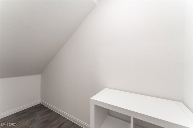 2902 Hemi Orange Ave, North Las Vegas, NV 89086 - bonus room featuring baseboards, dark wood-style floors, and vaulted ceiling