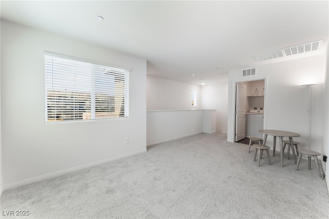 2902 Hemi Orange Ave, North Las Vegas, NV 89086 - spare room featuring washer / clothes dryer, carpet flooring, baseboards, and visible vents