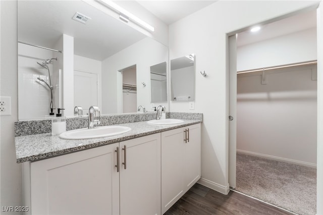 2902 Hemi Orange Ave, North Las Vegas, NV 89086 - bathroom featuring a sink, visible vents, a walk in closet, and double vanity