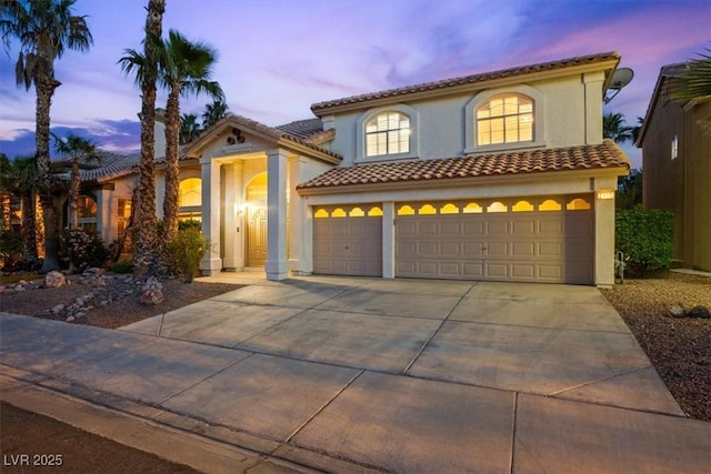 2445 Antler Point Dr, Henderson, NV 89074 - mediterranean / spanish home with an attached garage, driveway, stucco siding, and a tile roof