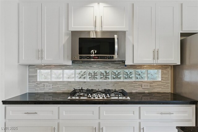 2445 Antler Point Dr, Henderson, NV 89074 - kitchen featuring stainless steel appliances, white cabinets, and decorative backsplash