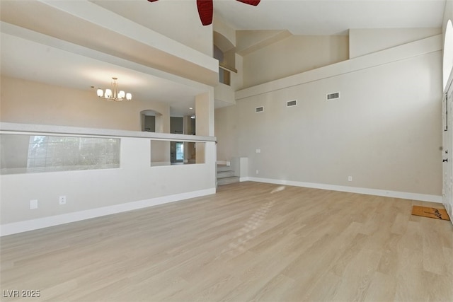 2445 Antler Point Dr, Henderson, NV 89074 - unfurnished room featuring ceiling fan, a chandelier, light wood-type flooring, high vaulted ceiling, and stairs