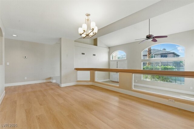 2445 Antler Point Dr, Henderson, NV 89074 - spare room featuring wood finished floors, a chandelier, vaulted ceiling, and a ceiling fan