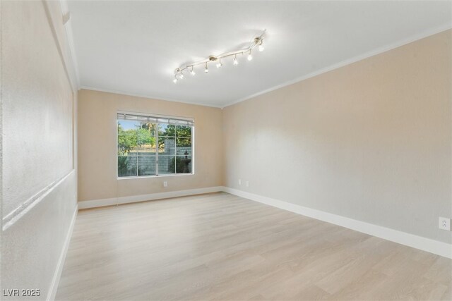2445 Antler Point Dr, Henderson, NV 89074 - spare room with crown molding and light wood finished floors