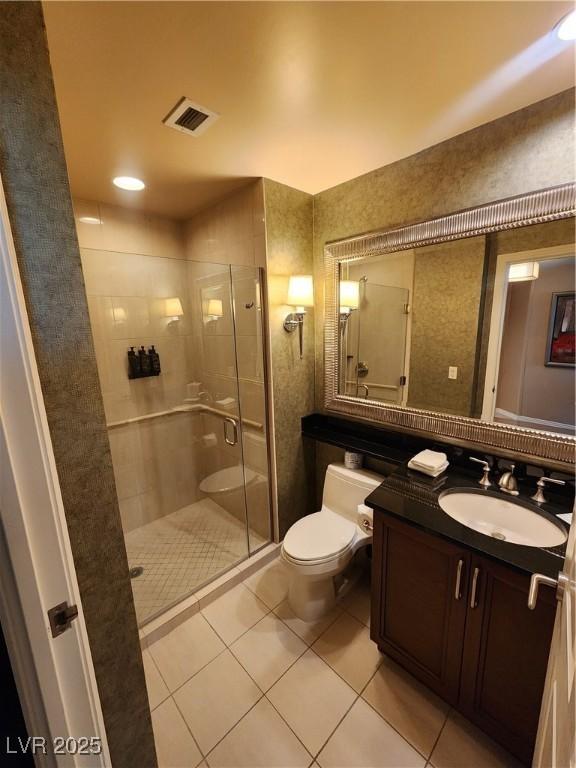 135 E Harmon Ave Unit 3320, Las Vegas, NV 89109 - full bathroom featuring toilet, a shower stall, tile patterned flooring, and vanity