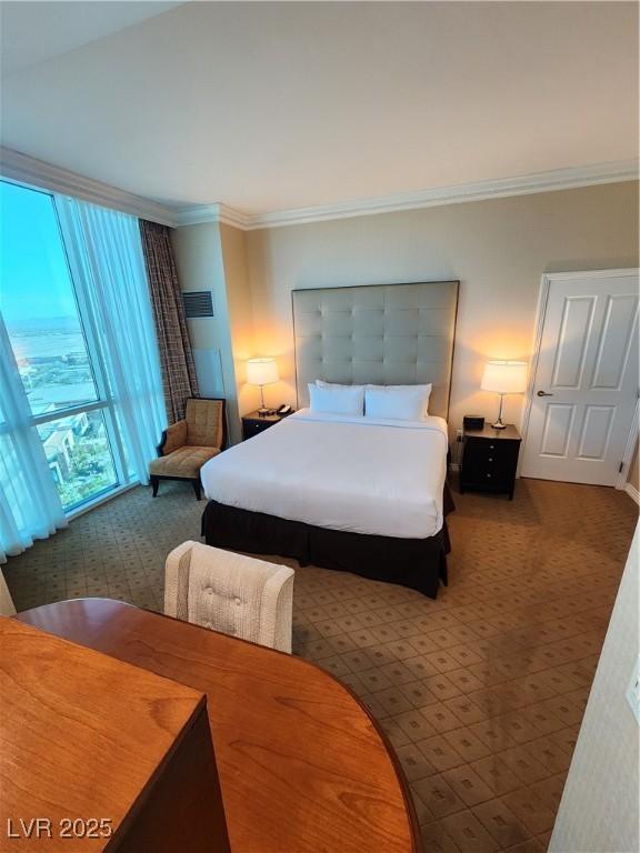 135 E Harmon Ave Unit 3320, Las Vegas, NV 89109 - bedroom featuring carpet and ornamental molding
