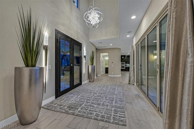 10 Olympia Outlook Dr, Las Vegas, NV 89141 - interior space featuring baseboards, an inviting chandelier, french doors, and light wood finished floors