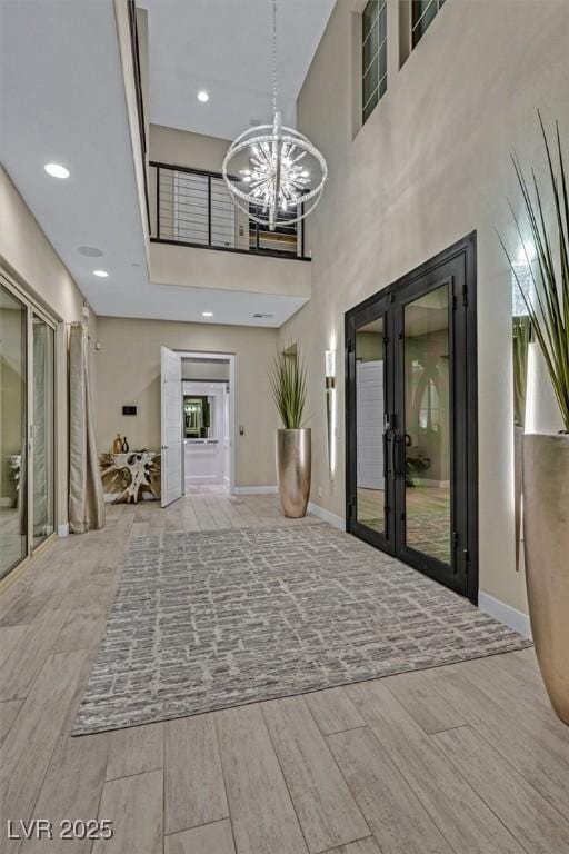 10 Olympia Outlook Dr, Las Vegas, NV 89141 - entrance foyer featuring baseboards, a notable chandelier, french doors, and wood finished floors