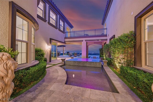 10 Olympia Outlook Dr, Las Vegas, NV 89141 - patio terrace at dusk with a balcony