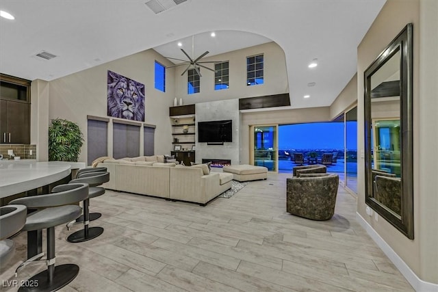 10 Olympia Outlook Dr, Las Vegas, NV 89141 - living room featuring a towering ceiling, visible vents, recessed lighting, and light wood-style flooring