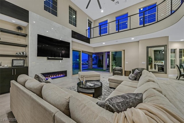 10 Olympia Outlook Dr, Las Vegas, NV 89141 - living area with baseboards, recessed lighting, a fireplace, a towering ceiling, and a ceiling fan