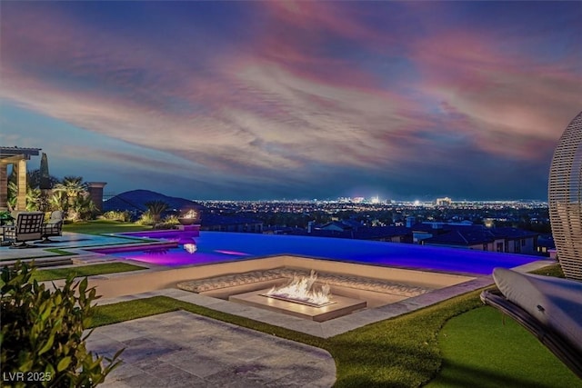 10 Olympia Outlook Dr, Las Vegas, NV 89141 - view of swimming pool featuring an infinity pool, a patio, and an outdoor fire pit