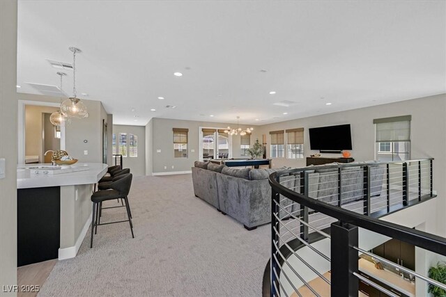 10 Olympia Outlook Dr, Las Vegas, NV 89141 - living room with plenty of natural light, baseboards, recessed lighting, and a chandelier