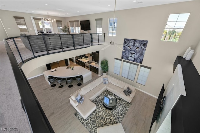 10 Olympia Outlook Dr, Las Vegas, NV 89141 - living area with ceiling fan with notable chandelier, baseboards, wood finished floors, and recessed lighting