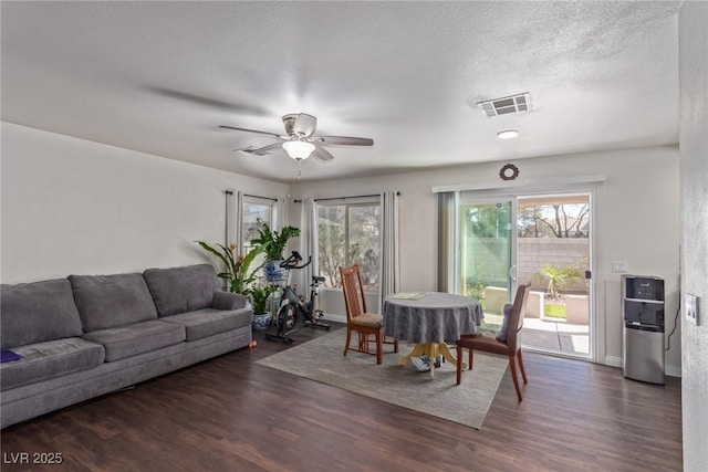 10103 Flagstaff Butte Ave, Las Vegas, NV 89148 - living room with visible vents, a ceiling fan, wood finished floors, and a textured ceiling