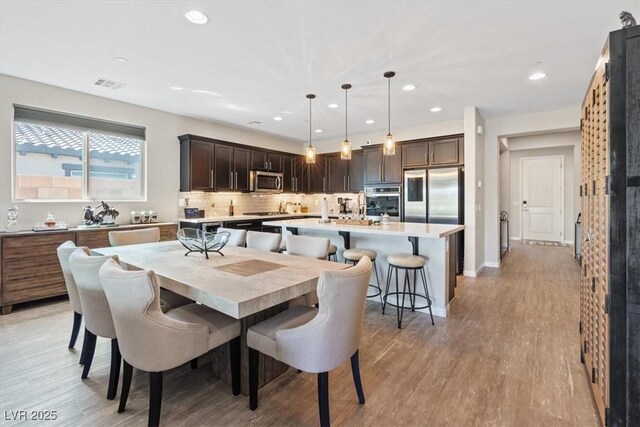 1225 Olivia Pkwy, Henderson, NV 89011 - dining room featuring visible vents, baseboards, light wood-type flooring, and recessed lighting