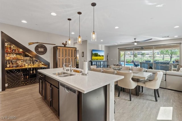 1225 Olivia Pkwy, Henderson, NV 89011 - kitchen featuring a sink, open floor plan, light wood-type flooring, recessed lighting, and stainless steel dishwasher