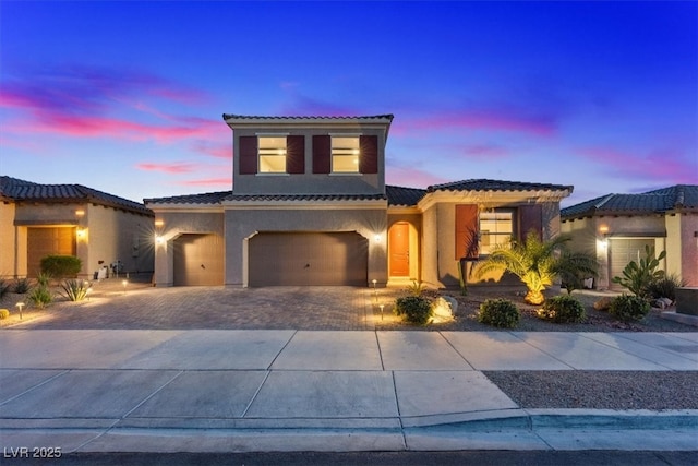 1225 Olivia Pkwy, Henderson, NV 89011 - mediterranean / spanish house with an attached garage, driveway, stucco siding, and a tile roof