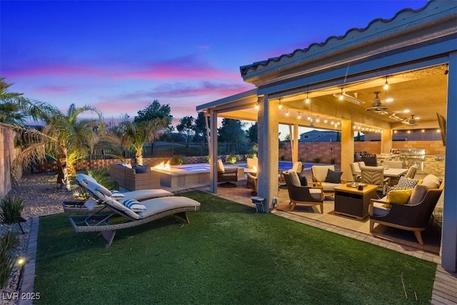 1225 Olivia Pkwy, Henderson, NV 89011 - view of patio featuring an outdoor living space with a fire pit, a fenced backyard, a ceiling fan, and exterior kitchen