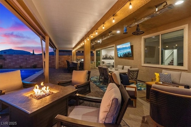 1225 Olivia Pkwy, Henderson, NV 89011 - patio terrace at dusk with an outdoor living space with a fire pit and fence