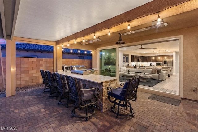 1225 Olivia Pkwy, Henderson, NV 89011 - view of patio / terrace featuring outdoor lounge area, ceiling fan, fence, outdoor dry bar, and an outdoor kitchen